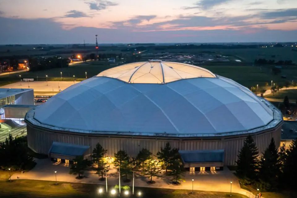 A large dome shaped building with lights on top.