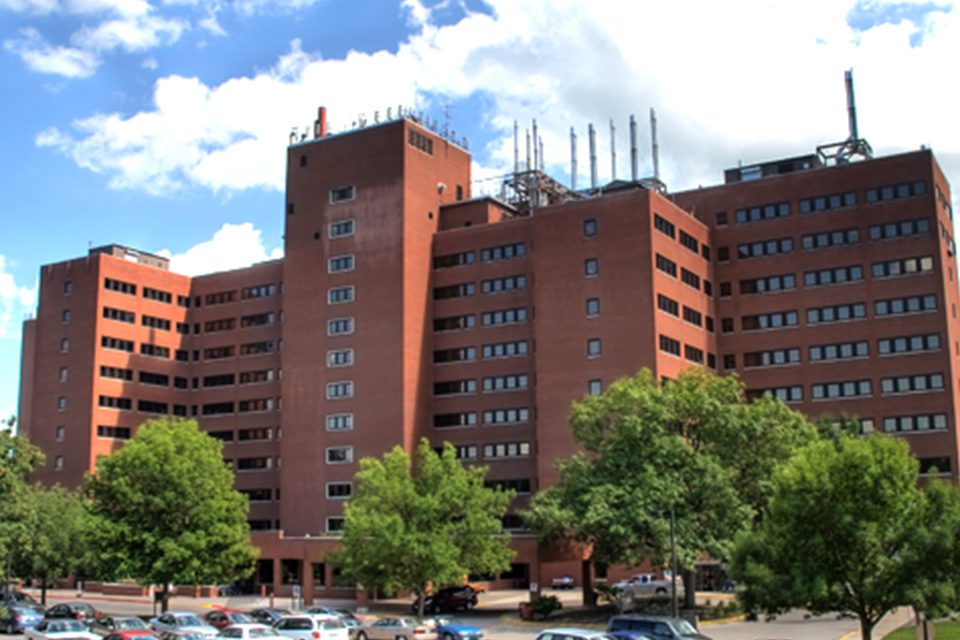 A large building with many windows and trees
