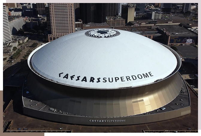 A large white dome with the words " caesars superdome ".