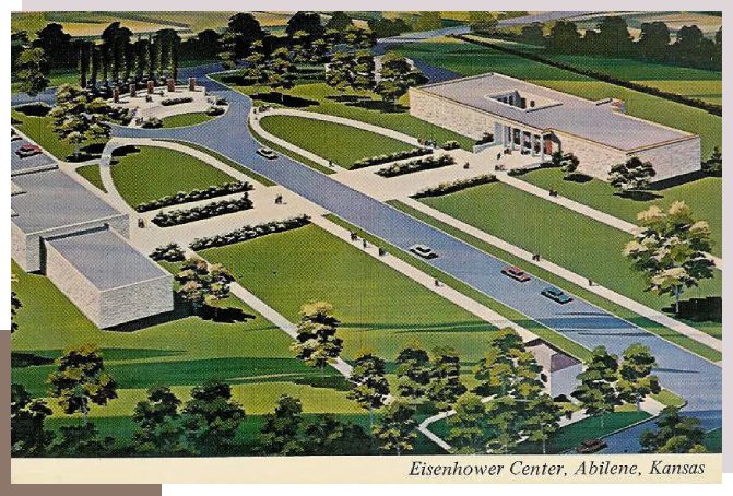 An aerial view of a large building with trees in the background.